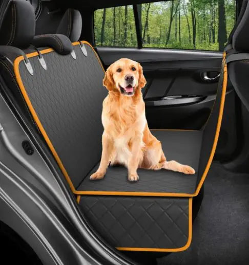 Golden retriever sitting on the black and orange waterproof seat cover fitted across the back seat of a car